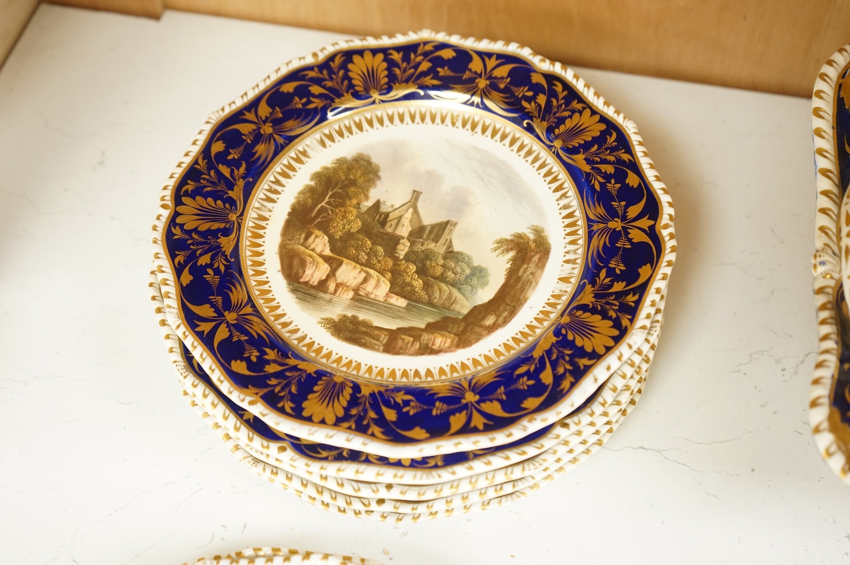 A Bloor Derby titled view part dessert service, c.1820 to include View on the Wye and View in Yorkshire, largest 29cm wide (16)